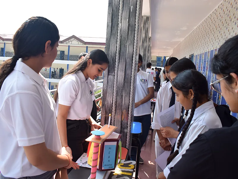 A student demonstrating a project to classmates at the StemSkills science fair
